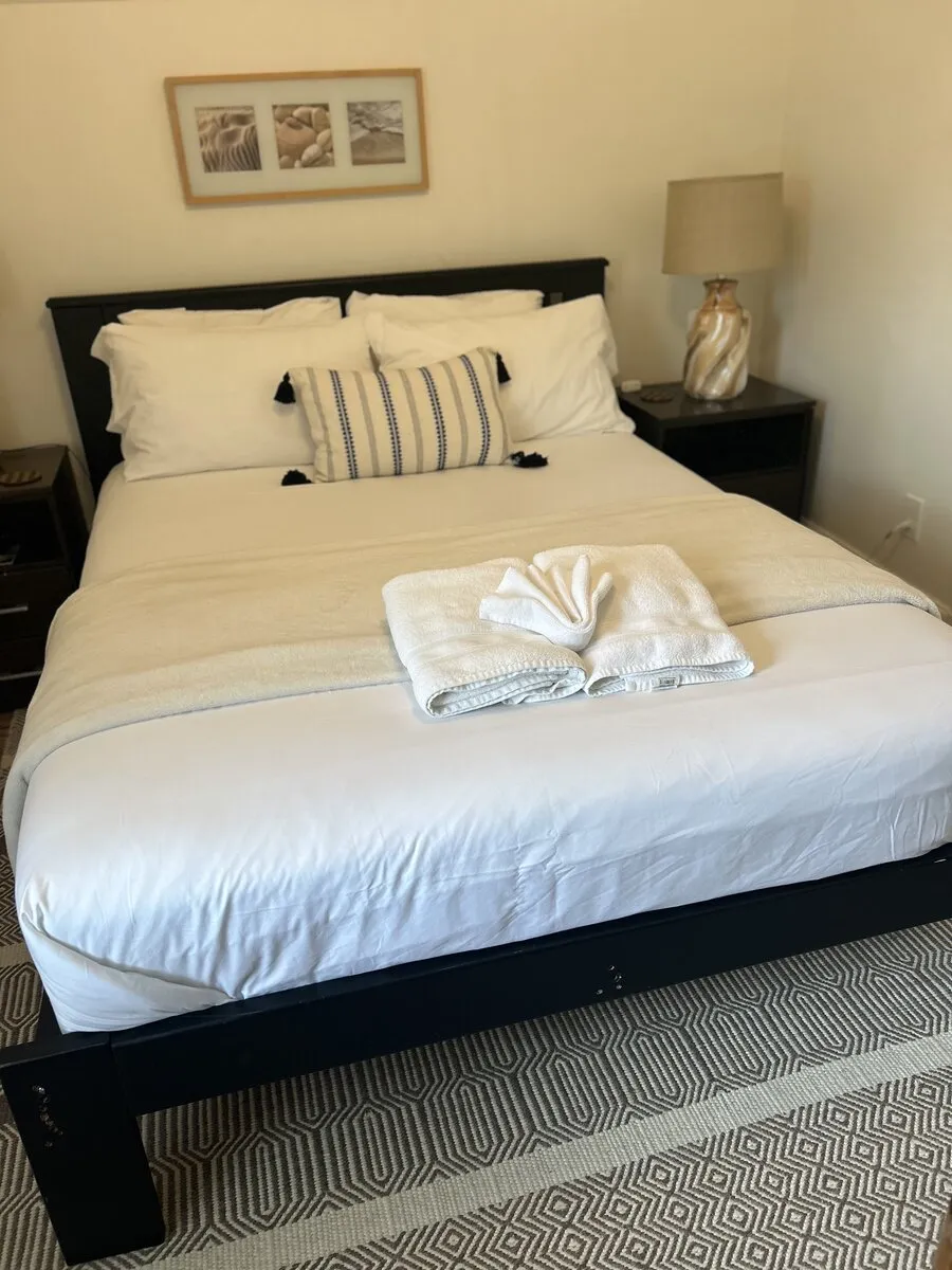 Bedroom with the bed made after house cleaning