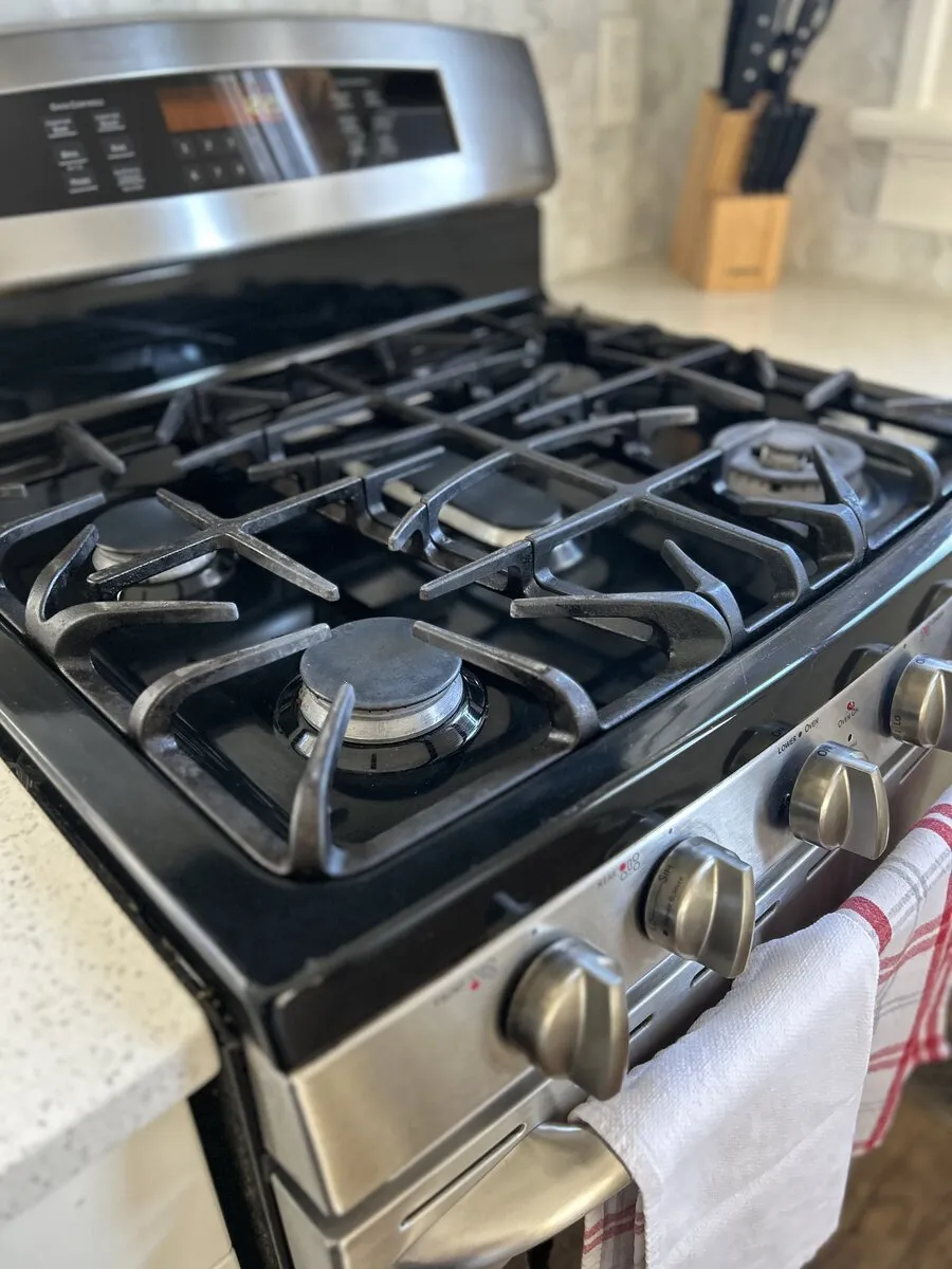 Polished stovetop and kitchen surfaces after house cleaning