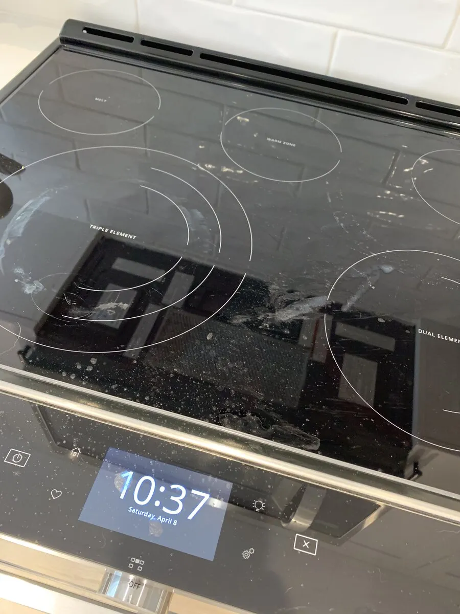 Gas cooktop with grease and spills before cleaning