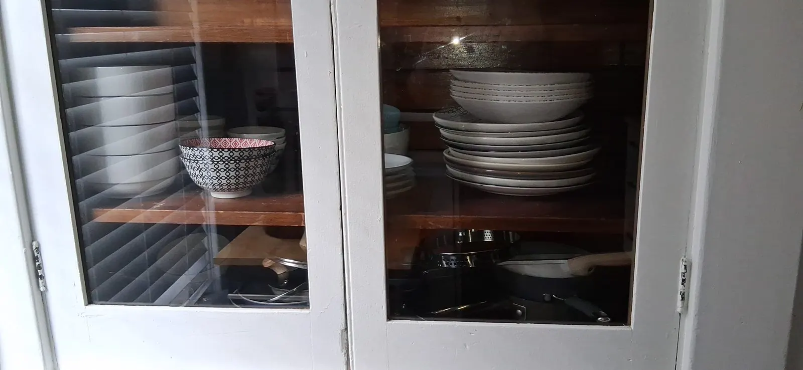 Dishware cabinet restocked during a turnover