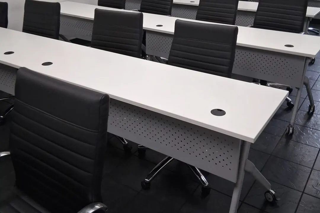 Clean meeting and training room with tables and chairs reset