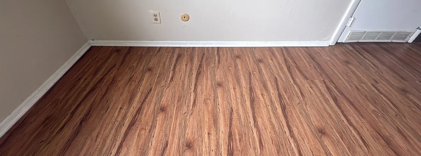 Close-up of a cleaned baseboard and floor edge