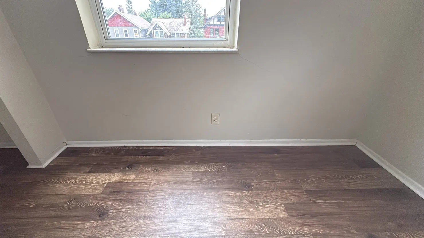 Empty room with clean floors and baseboards, ready for move-in